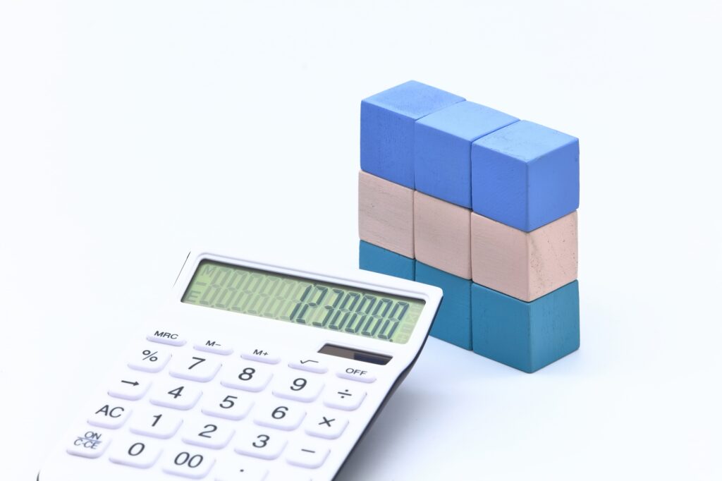 住宅ローンの返済計画を考える電卓と積み上げたブロック
